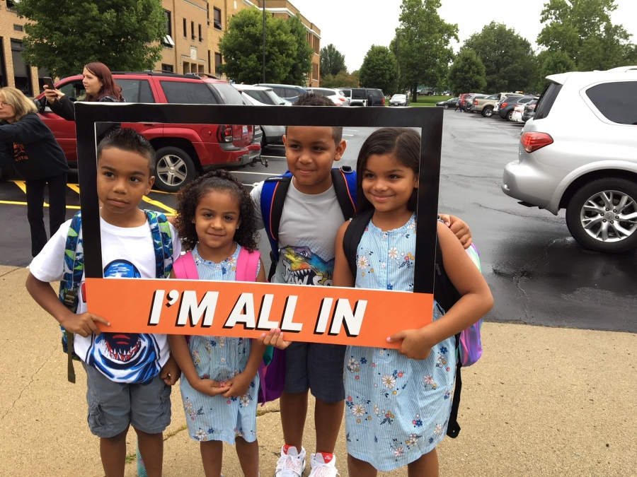 people holding a frame sign